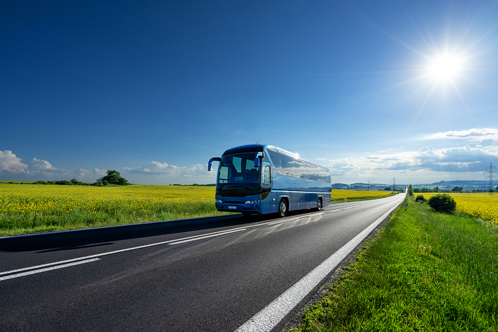 A modern bus going from "Bantry to Cork" with the scenic Irish countryside in the background.