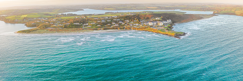 Pristine golden sands and azure waters of Clonakilty Beach on a sunny day.