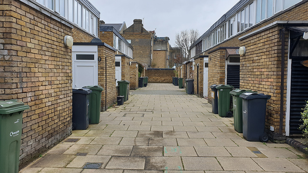 Pristine street with well-maintained sidewalks and greenery, recognized in the Tidy Towns 2022 initiative.