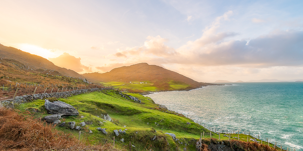 Rolling hills and vibrant green grass in West Cork, Ireland.