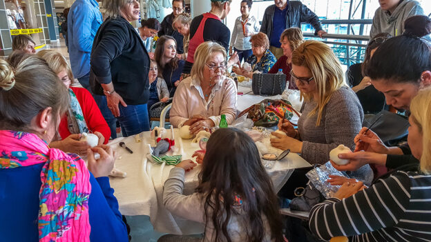 A bustling Timebank Community Centre with members engaged in various activities.